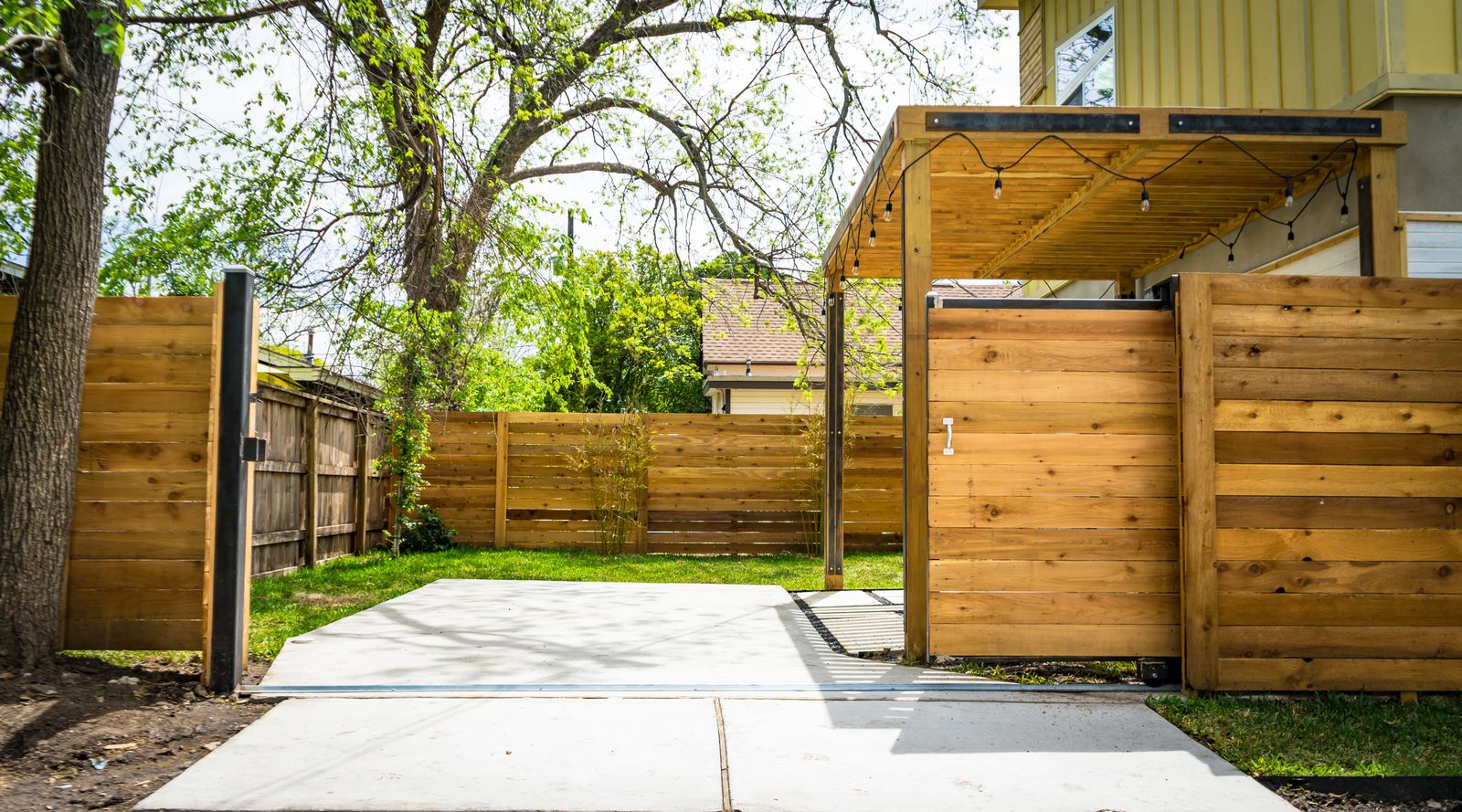 A horizontal-slat cedar fence with a matching gate